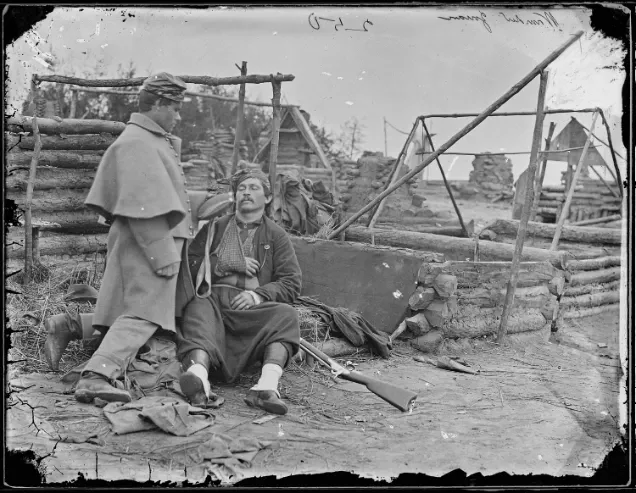 Mathew Brady-Scene showing deserted camp and wounded Soldier